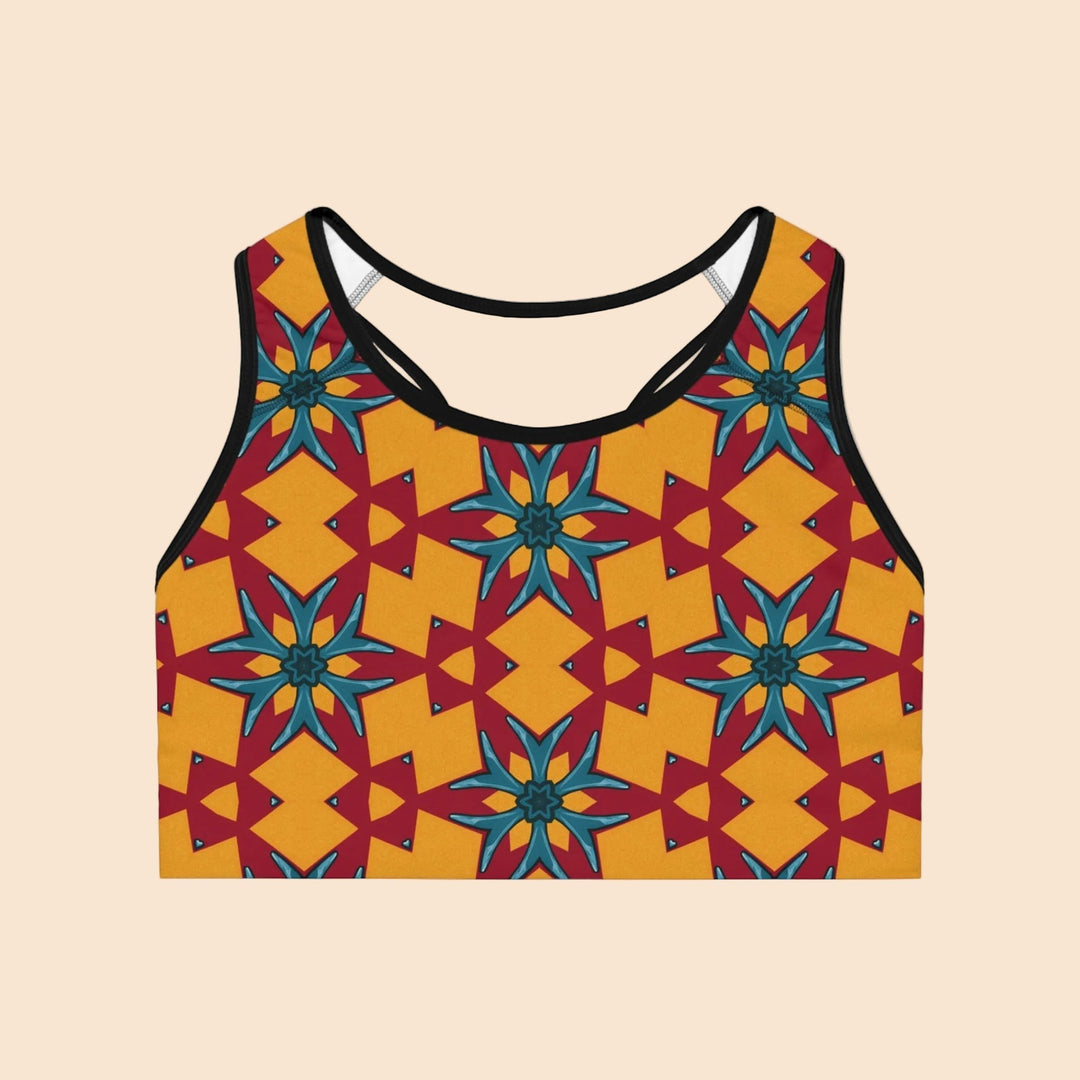 Sea Dragon Dreams sports bra featuring a vibrant red and yellow geometric floral pattern with black trim