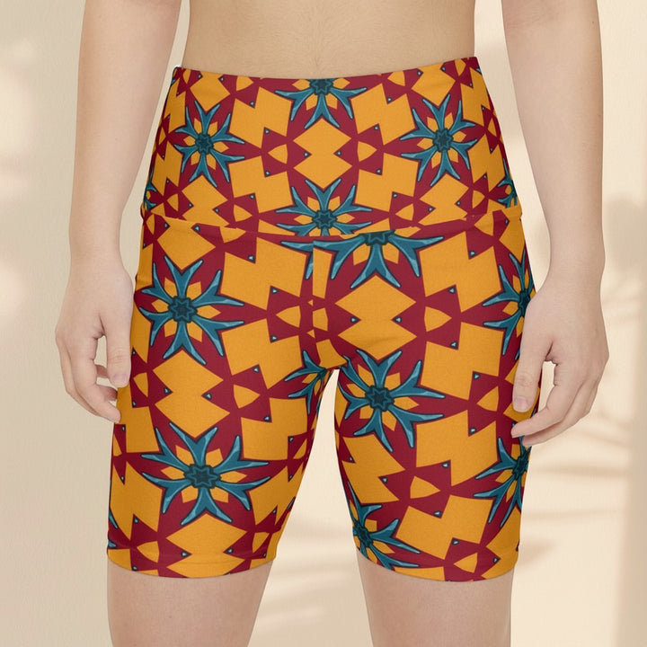 Sea Dragon Dreams women's workout shorts in a vibrant red and yellow geometric floral pattern, made of polyester.