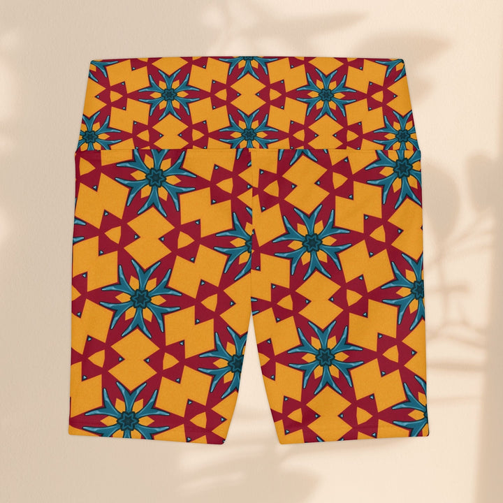 Sea Dragon Dreams women's workout shorts in a vibrant red and yellow geometric floral pattern made of polyester.