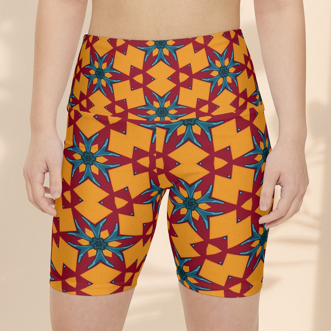 Sea Dragon Dreams women's workout shorts featuring a vibrant red and yellow geometric floral pattern in polyester.