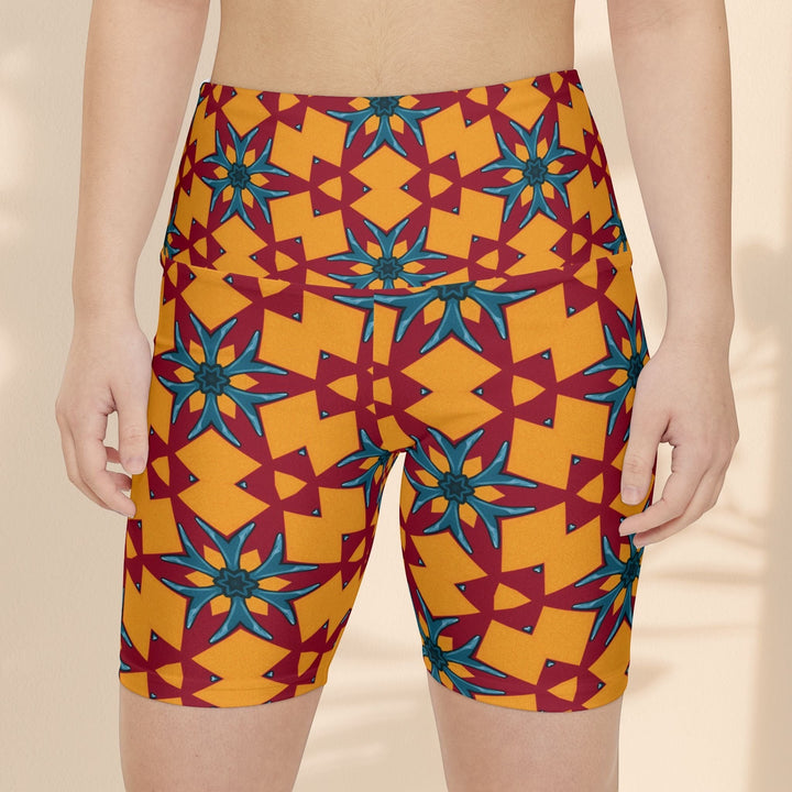 Sea Dragon Dreams women's workout shorts featuring a vibrant red and yellow geometric floral pattern in polyester.