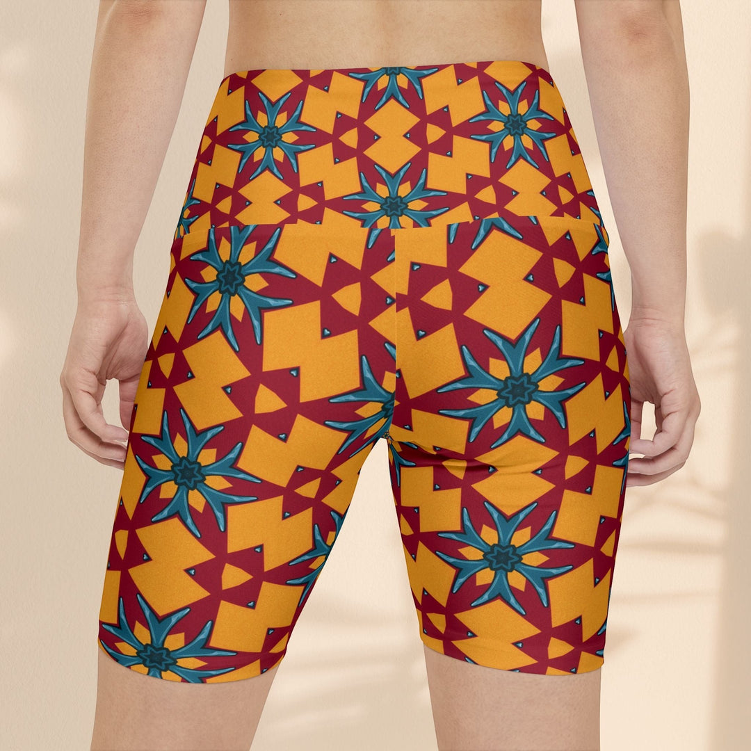 Sea Dragon Dreams women's workout shorts in a vibrant red and yellow geometric floral pattern with a high-waist fit.