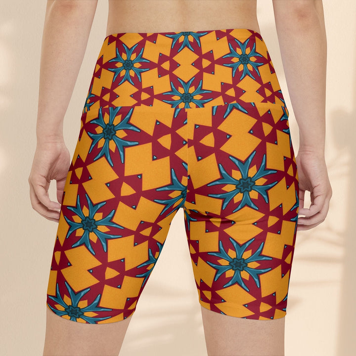 Sea Dragon Dreams women's workout shorts in a vibrant red and yellow geometric floral pattern with a high-waist fit.