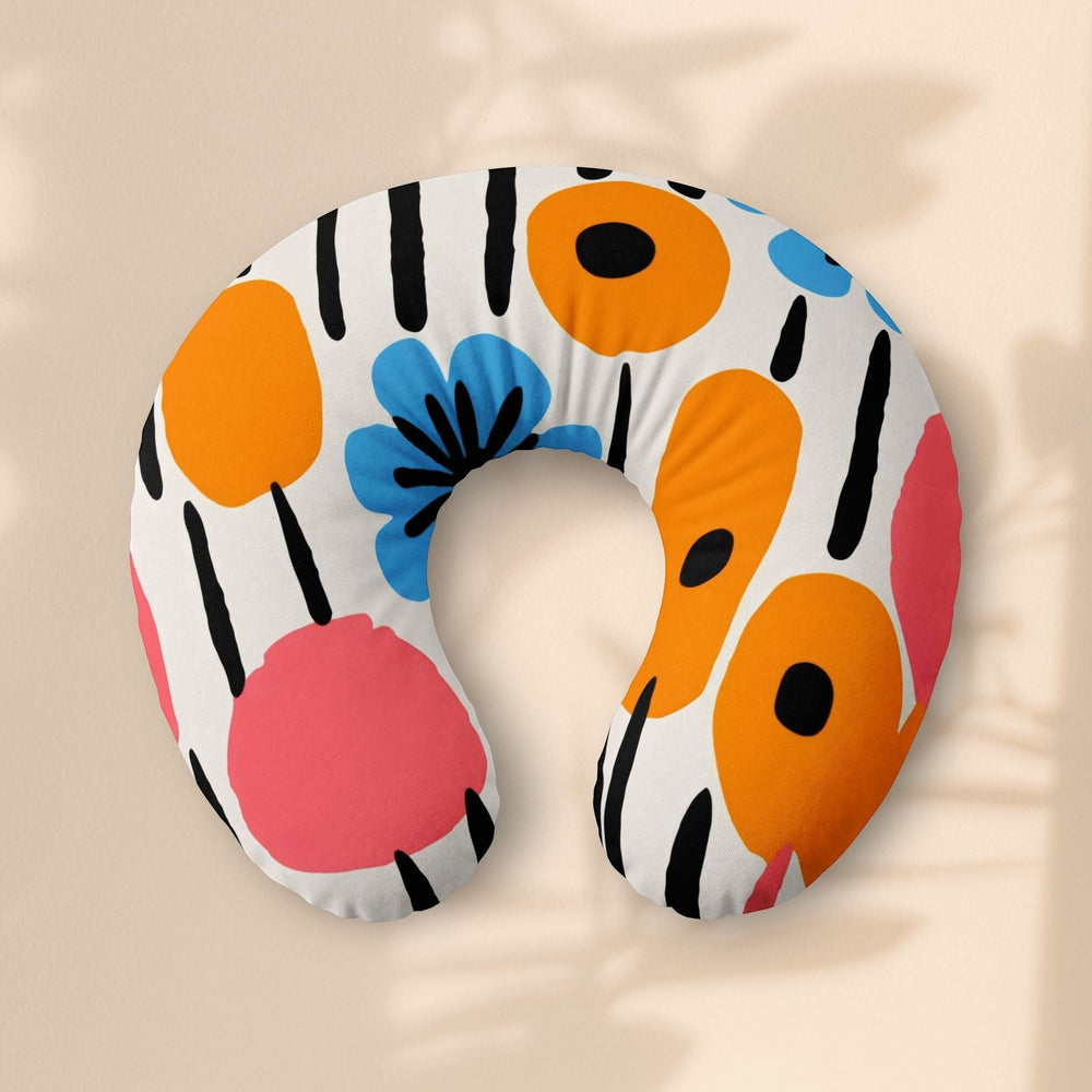 Sea Dragon Dreams nursing pillow cover with a retro-inspired floral pattern in orange, blue, and pink on white.