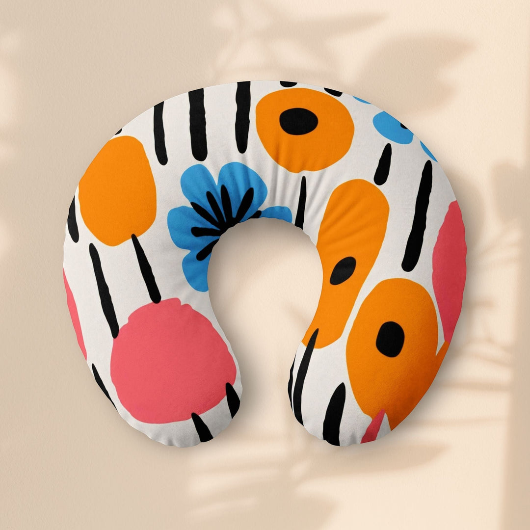 Sea Dragon Dreams nursing pillow cover with a retro-inspired floral pattern in orange, blue, and pink on white.