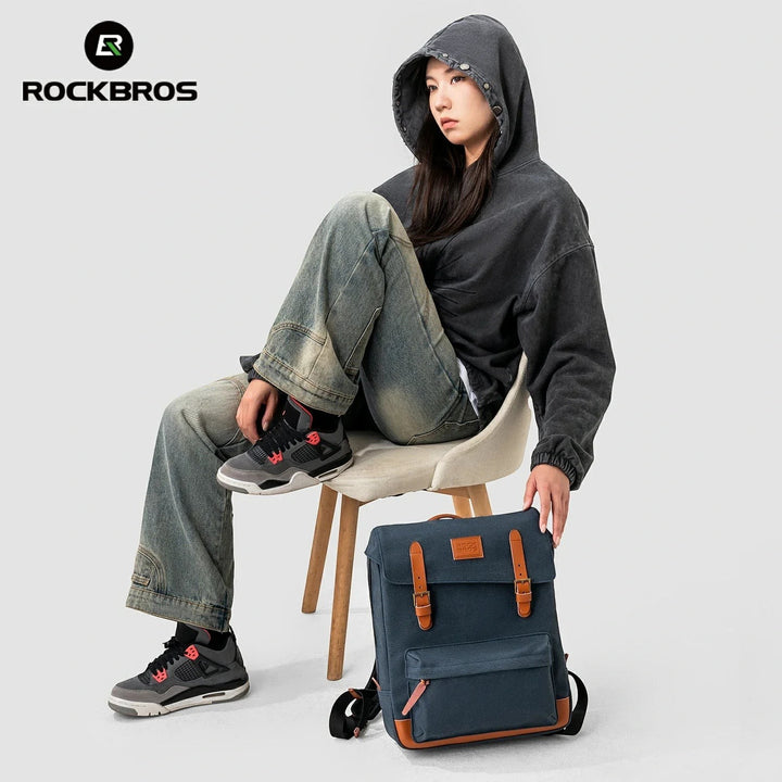 Sea Dragon Dreams ROCKBROS blue cotton vintage-style folding bike backpack with leather trim sitting on a chair