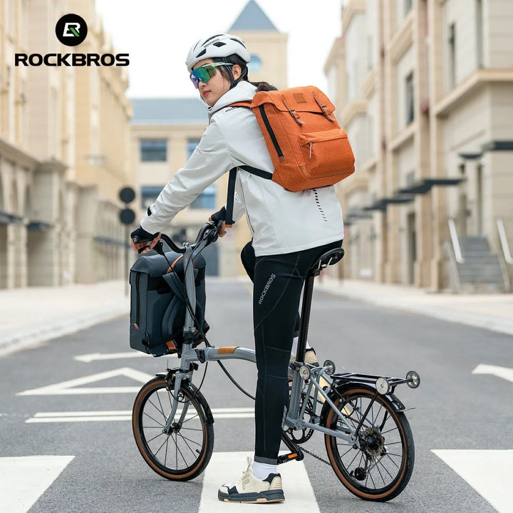 Sea Dragon Dreams ROCKBROS vintage orange polyester folding bike backpack worn by a cyclist on a city street