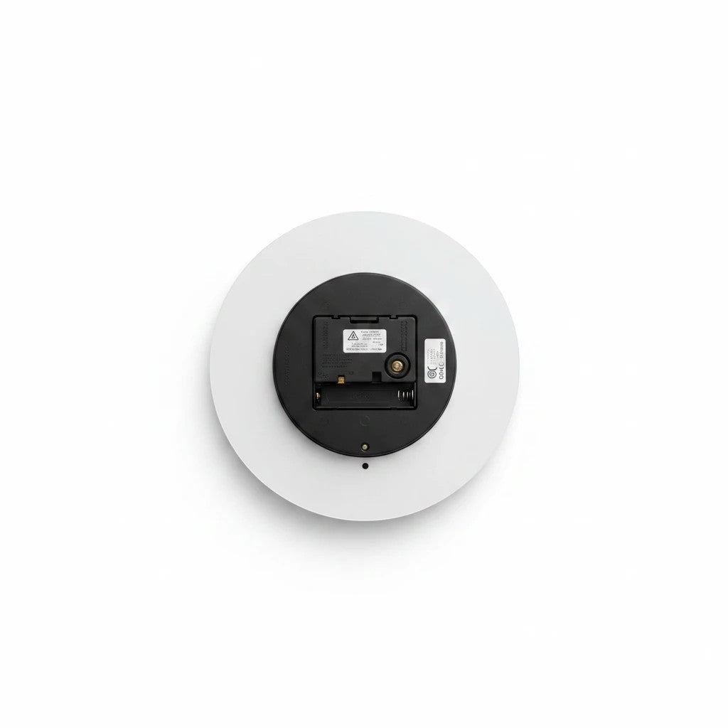 Back view of a Sea Dragon Dreams round acrylic wall clock showing the black battery mechanism and hanging slot.