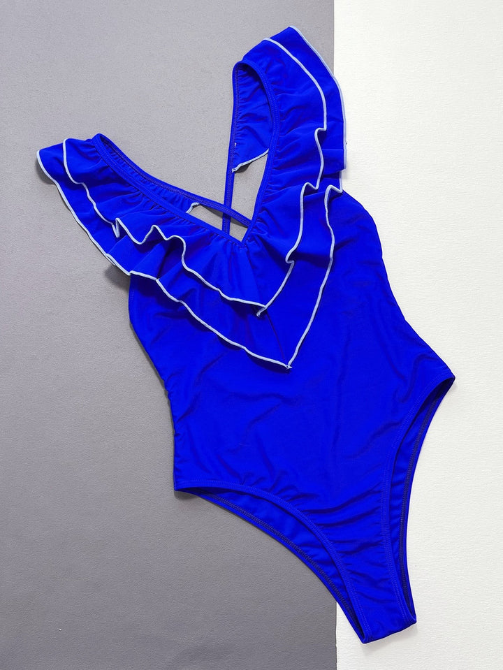 Sea Dragon Dreams royal blue one-piece swimsuit with ruffled V-neckline and crisscross backless design.