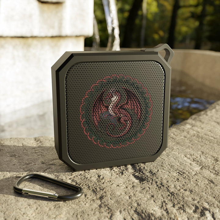 Sea Dragon Dreams rugged portable Bluetooth speaker with dragon emblem, black ABS plastic housing, and carabiner clip.