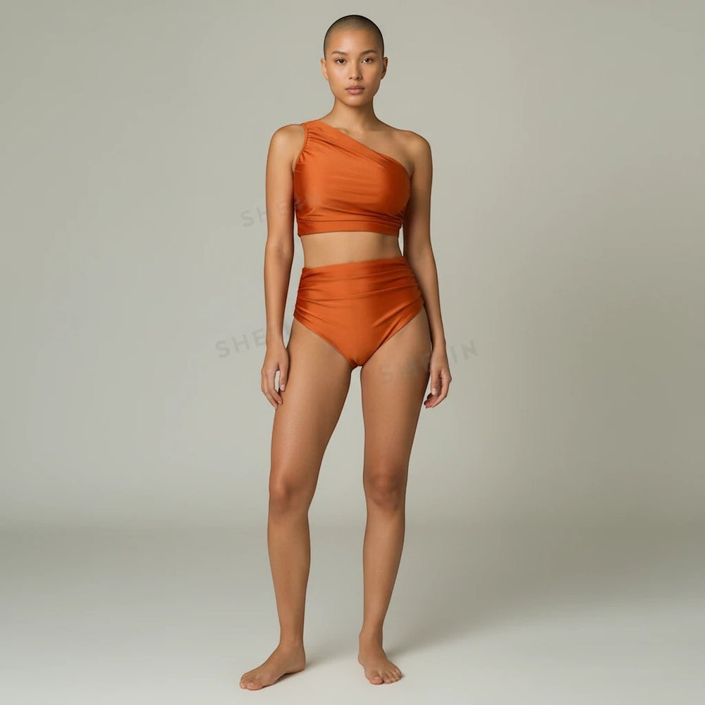 Sea Dragon Dreams rust orange one-shoulder bikini set with high-waisted bottoms on a model