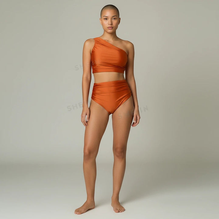 Sea Dragon Dreams rust orange one-shoulder bikini set with high-waisted bottoms on a model