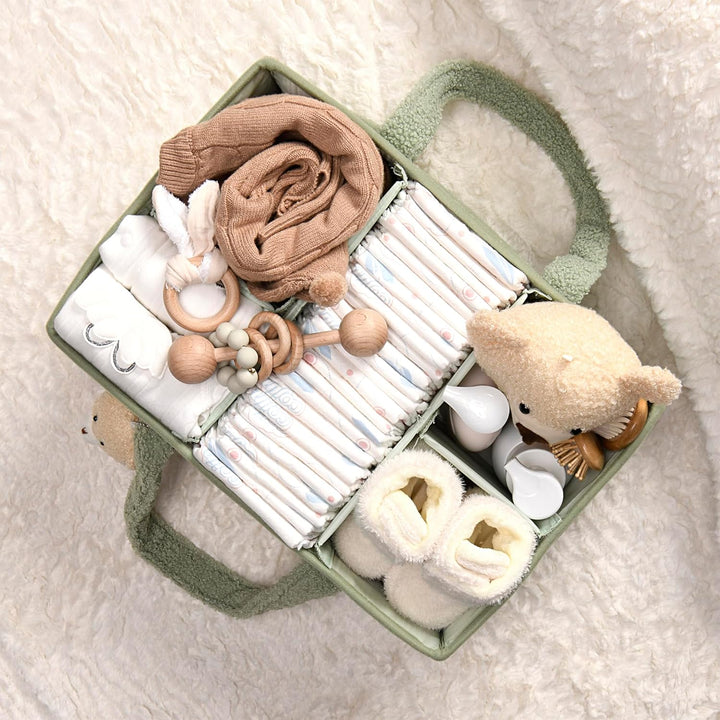 Sea Dragon Dreams sage green plush sherpa diaper caddy filled with baby essentials, diapers, and a teddy bear charm