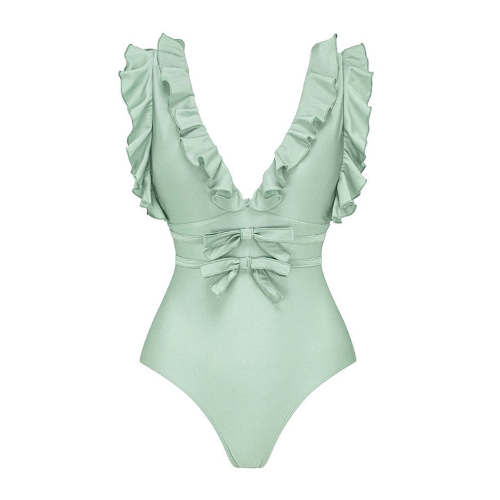 Sea Dragon Dreams sage green one-piece swimsuit with deep V-neck, ruffled shoulder straps, and double bow waist detail