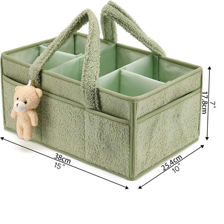 Sea Dragon Dreams sage green plush sherpa diaper caddy with removable dividers and an attached teddy bear charm.