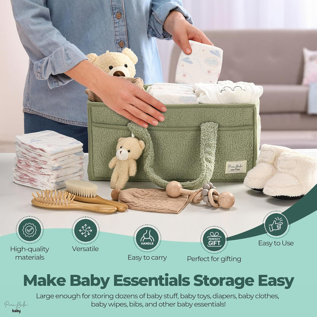 Sea Dragon Dreams sage green plush sherpa diaper caddy with teddy bear charm, holding baby essentials on a table.
