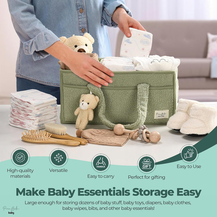 Sea Dragon Dreams sage green plush sherpa diaper caddy with teddy bear charm, holding baby essentials on a table.