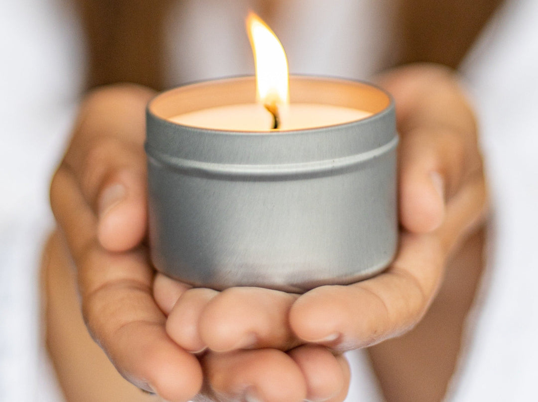 Sea Dragon Dreams scented soy candle in a silver tin held in hands, perfect for a relaxing self-care gift box.