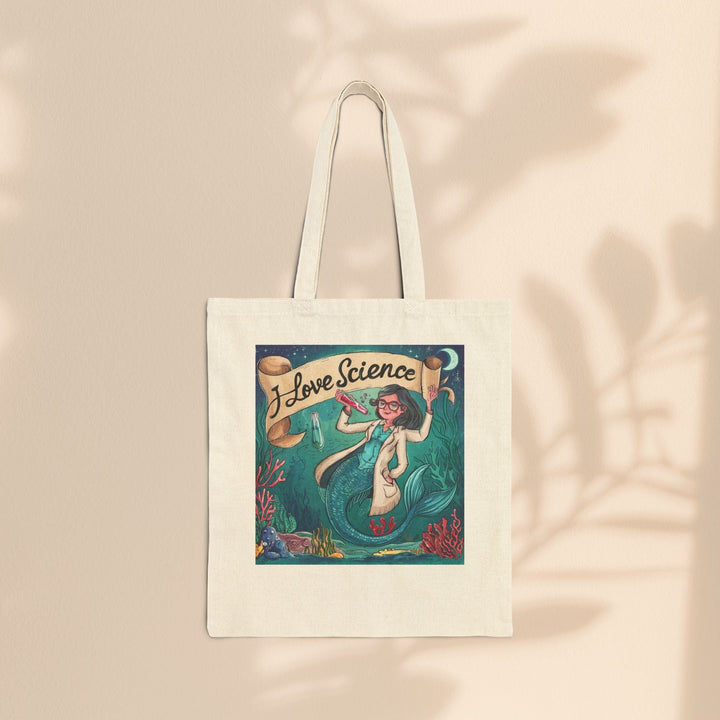 Sea Dragon Dreams cotton canvas tote bag featuring an I Love Science mermaid illustration on a beige background.