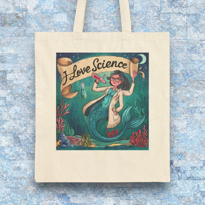 Sea Dragon Dreams cotton canvas tote bag featuring a mermaid scientist illustration with the text I Love Science