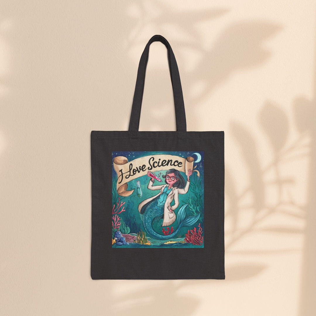 Sea Dragon Dreams black cotton canvas tote bag featuring an I Love Science mermaid scientist illustration.