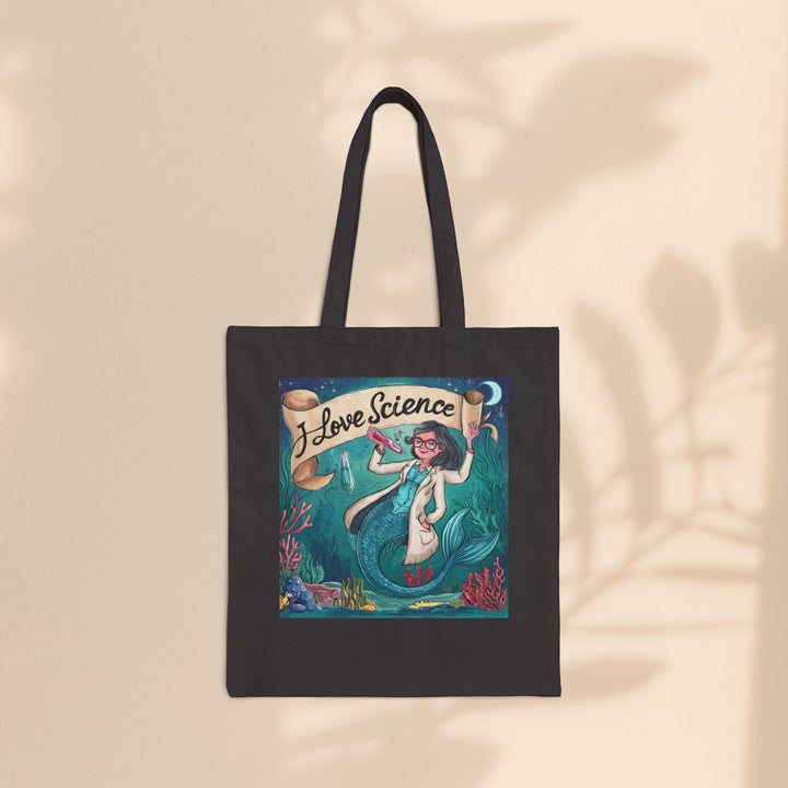 Sea Dragon Dreams black cotton canvas tote bag featuring an I Love Science mermaid scientist illustration.