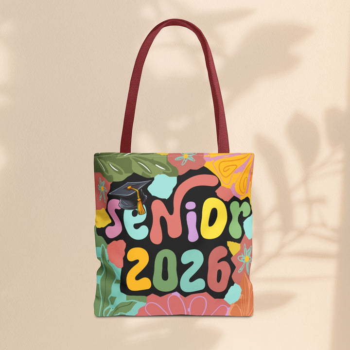 Sea Dragon Dreams Senior 2026 tote bag with colorful floral design, graduation cap graphic, and maroon handles.