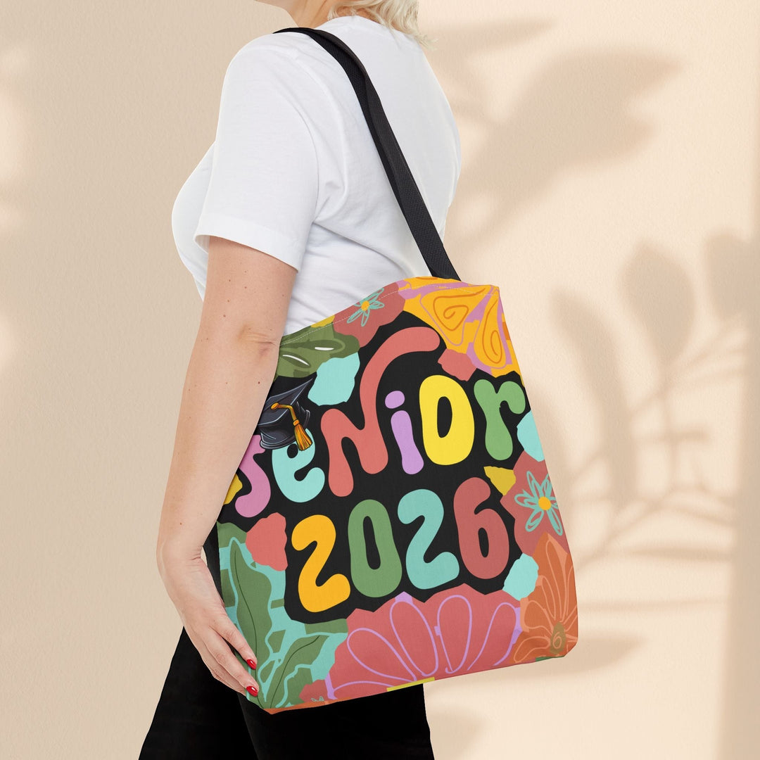 Sea Dragon Dreams Senior 2026 tote bag with colorful floral design and graduation cap, worn over the shoulder.