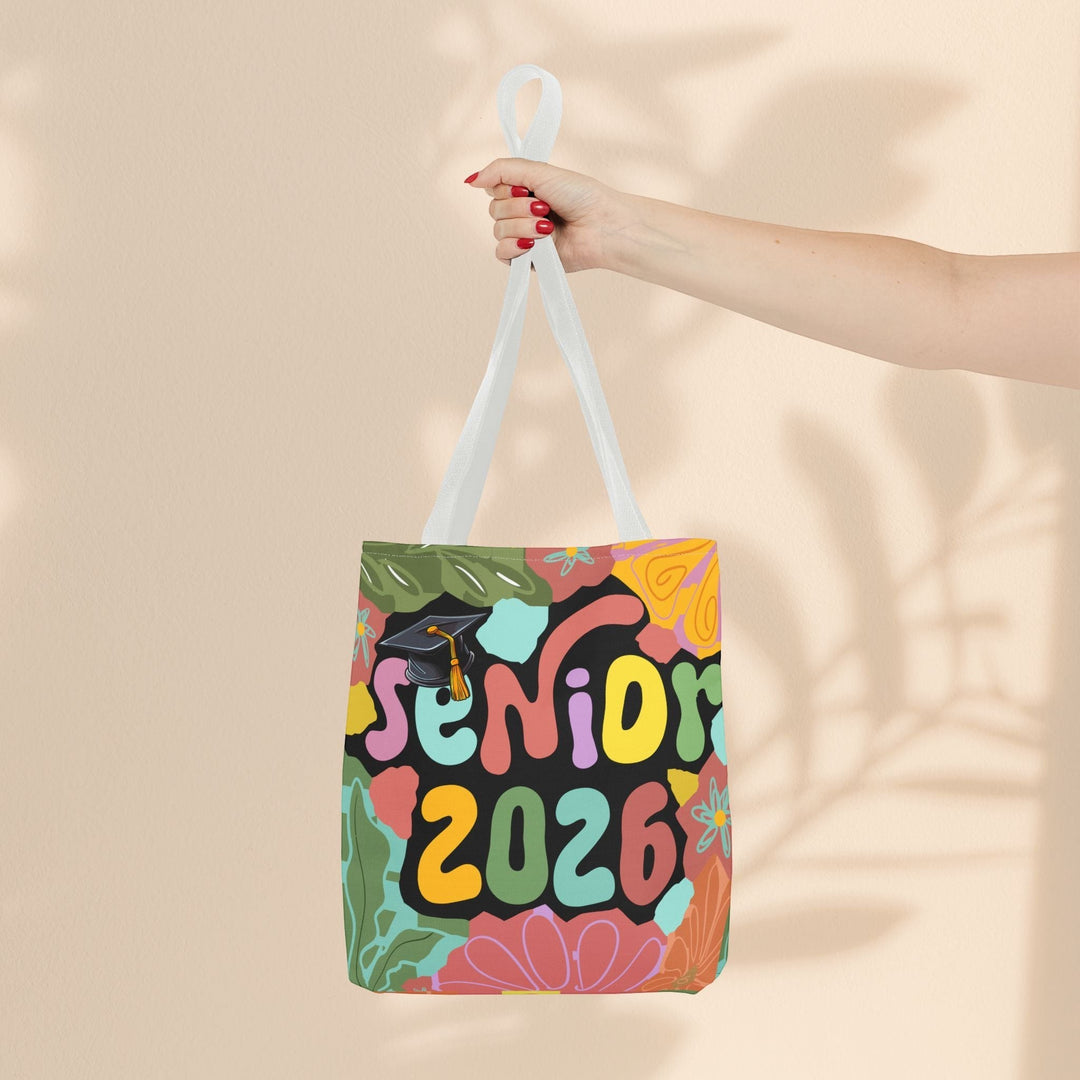 Sea Dragon Dreams Senior 2026 tote bag with colorful floral patterns and a graduation cap on a black background