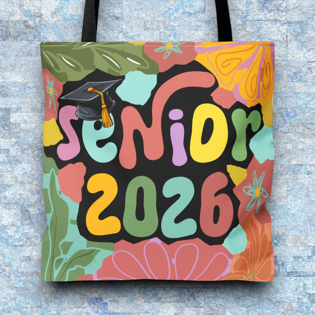 Sea Dragon Dreams Senior 2026 tote bag with colorful floral patterns, graduation cap, and black handles on blue background.