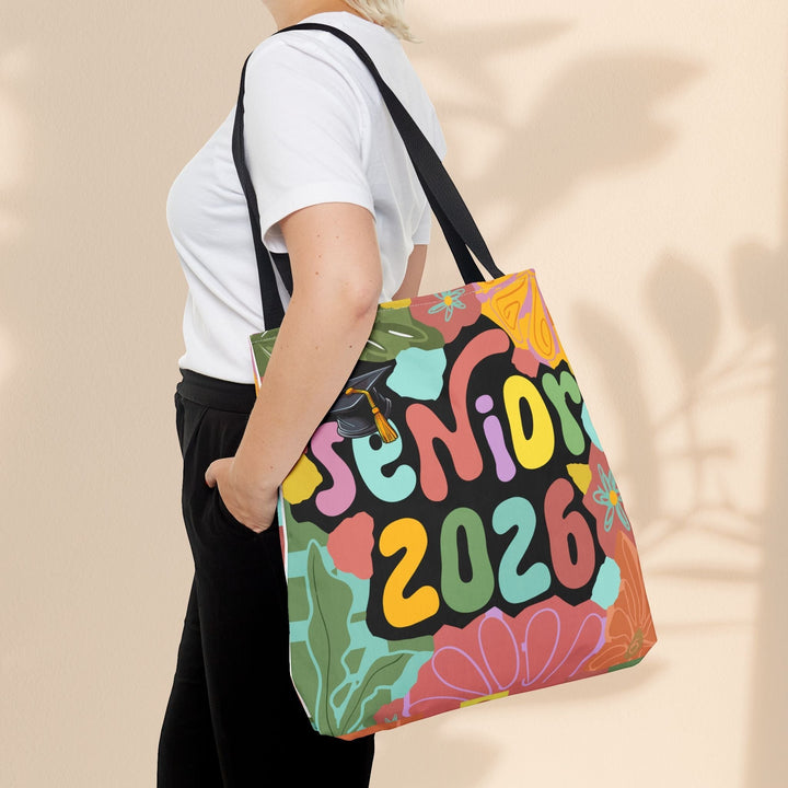 Sea Dragon Dreams Senior 2026 tote bag with colorful floral design and graduation cap, worn over the shoulder.