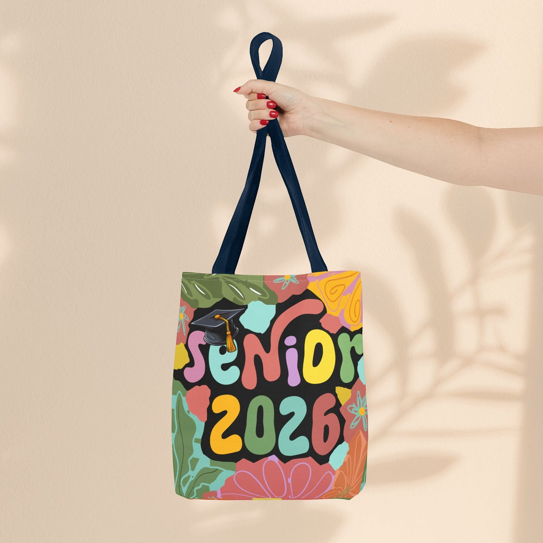 Sea Dragon Dreams Senior 2026 tote bag with colorful floral pattern, graduation cap, and navy blue handles.