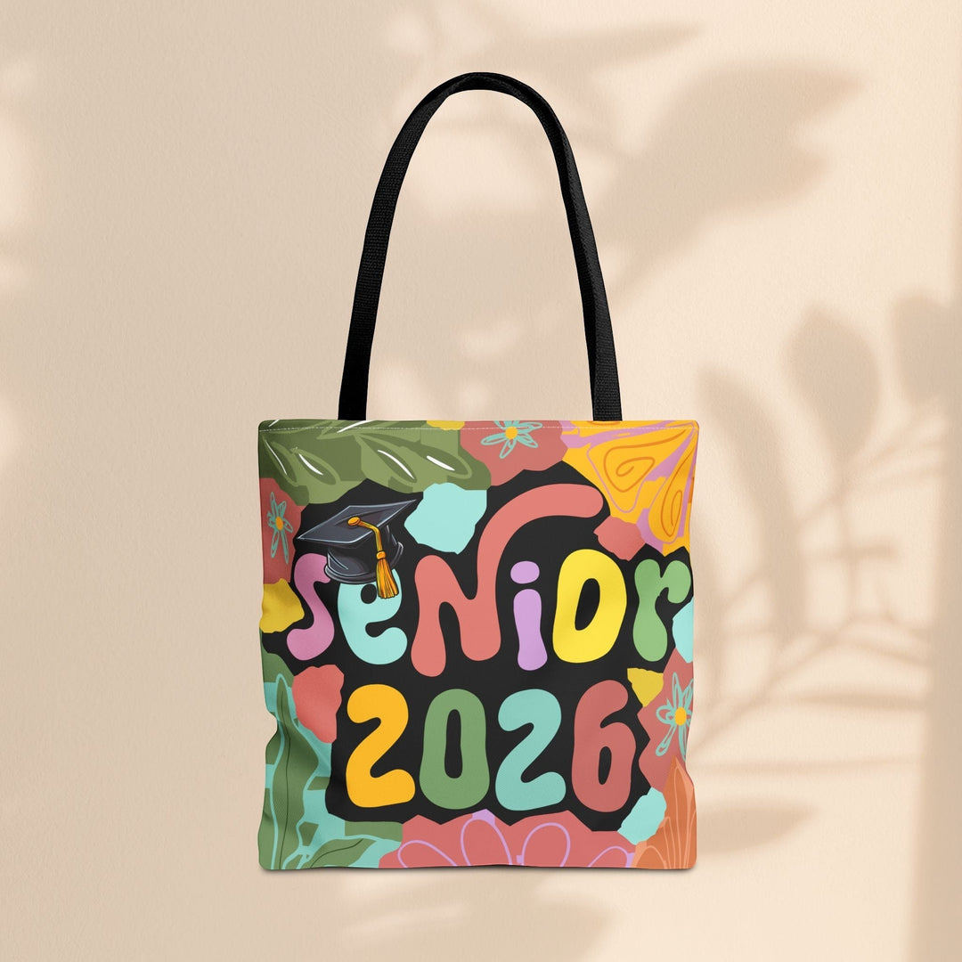Sea Dragon Dreams Senior 2026 tote bag with colorful floral patterns, black handles, and a graduation cap graphic.