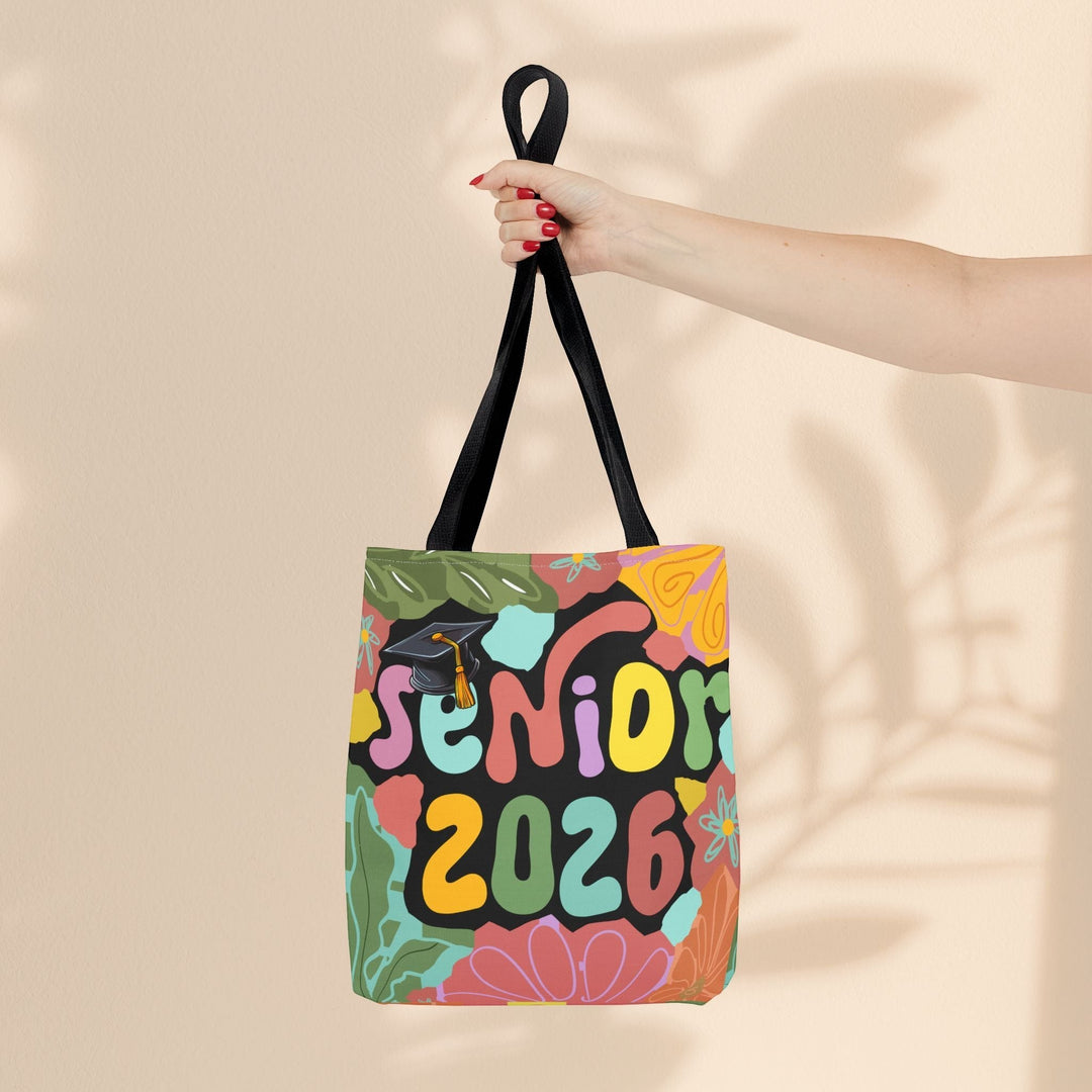 Sea Dragon Dreams Senior 2026 tote bag with colorful retro floral print and graduation cap graphic on polyester fabric.