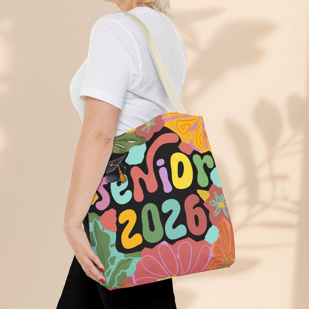 Sea Dragon Dreams Senior 2026 tote bag with colorful floral and graduation cap print worn over the shoulder