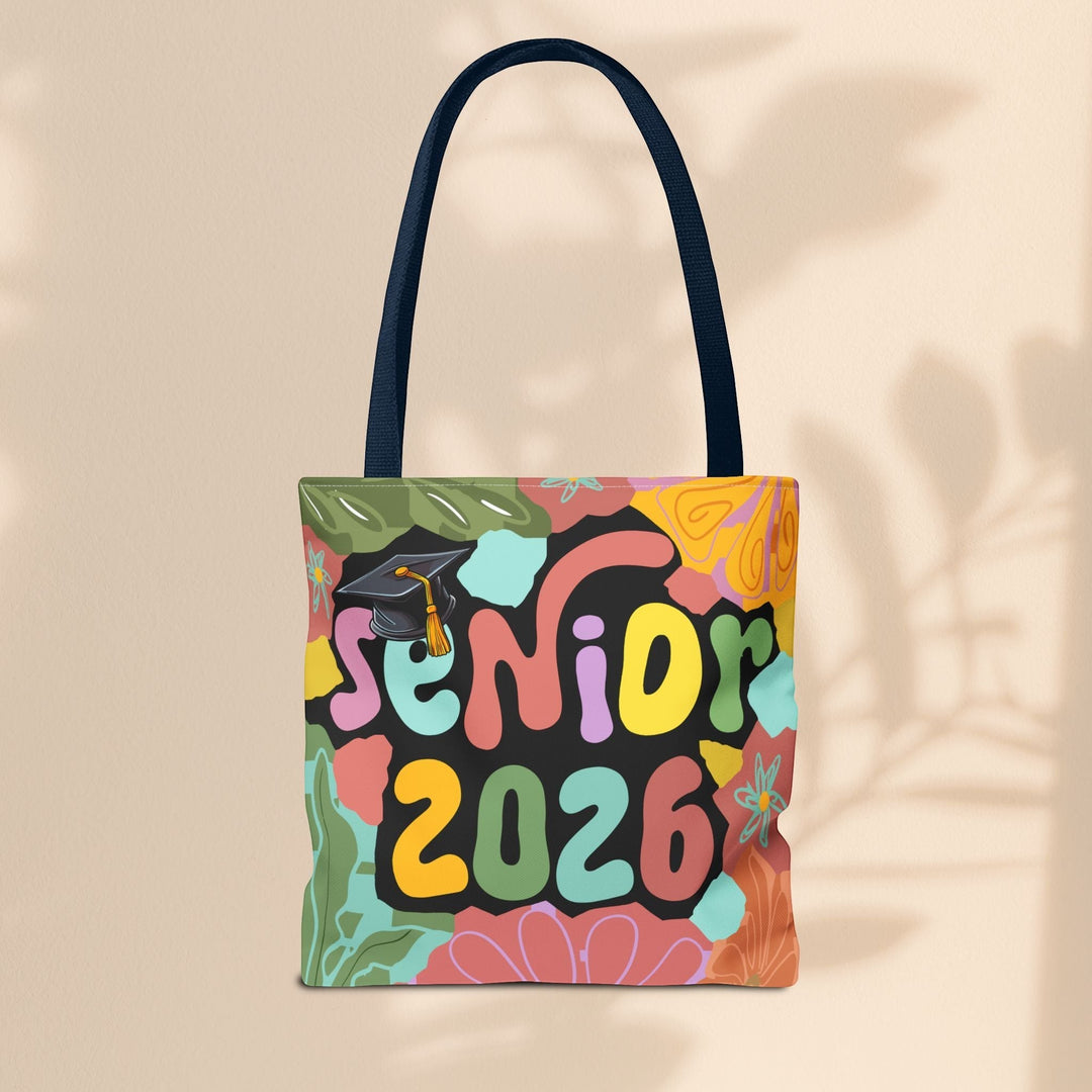 Sea Dragon Dreams Senior 2026 tote bag with colorful floral patterns and a graduation cap on a beige background.