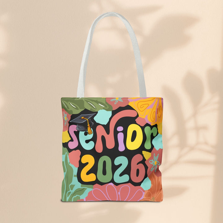 Sea Dragon Dreams Senior 2026 tote bag with colorful floral patterns, graduation cap graphic, and white cotton handles.