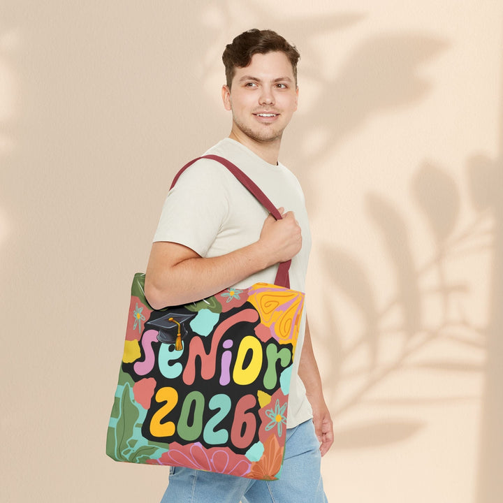 Sea Dragon Dreams Senior 2026 tote bag with colorful floral pattern and graduation cap, worn over the shoulder.