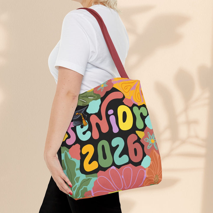 Sea Dragon Dreams Senior 2026 tote bag with colorful floral and graduation cap design, worn over the shoulder.