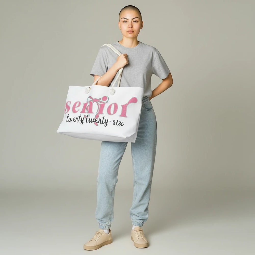 Sea Dragon Dreams Senior 2026 weekender bag in white polyester with pink text, carried by a model in casual clothes.