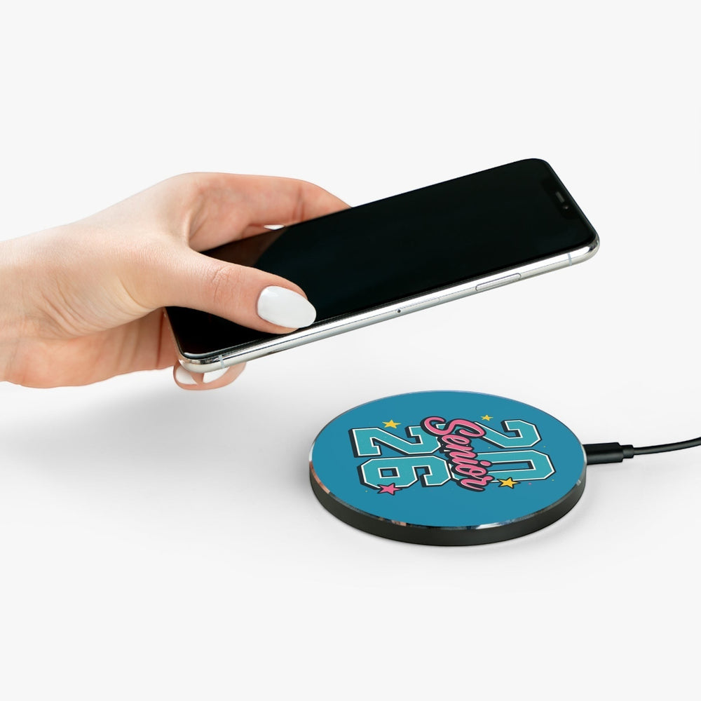 Sea Dragon Dreams Senior 2026 wireless charging pad with a blue graphic, held by a hand with a smartphone.