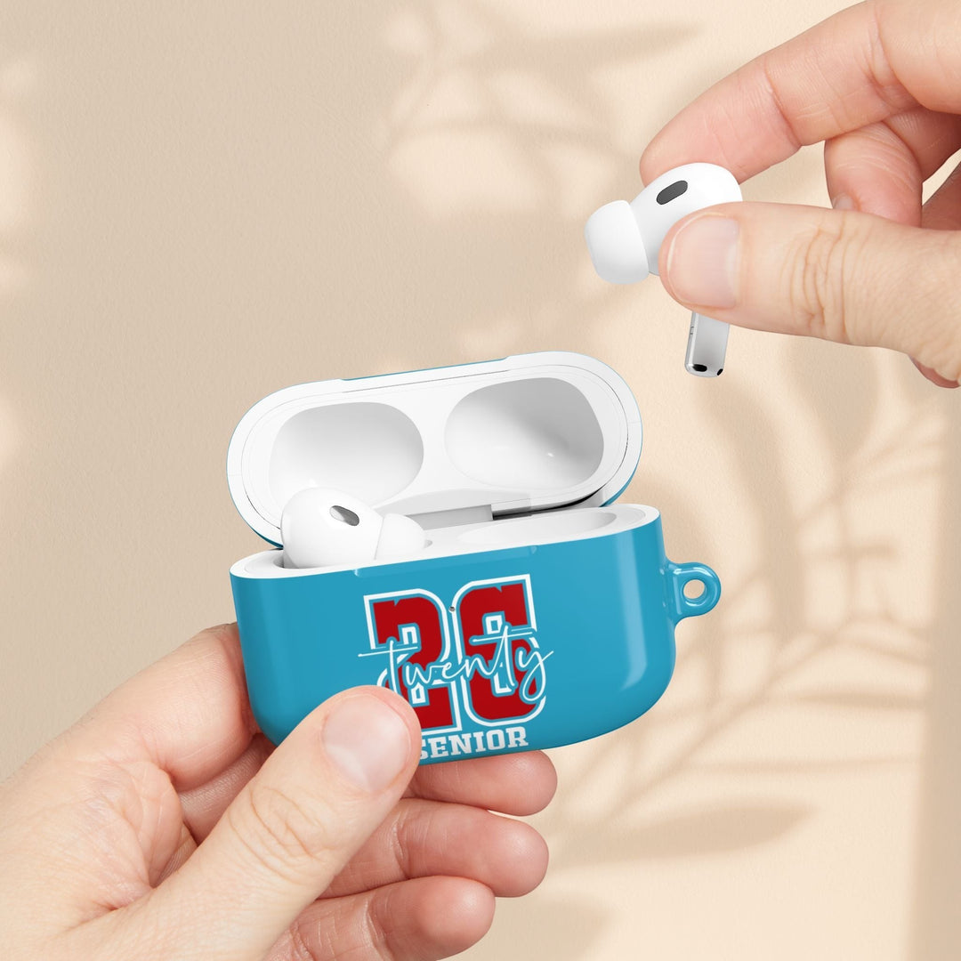 Sea Dragon Dreams Senior Year 2026 AirPod case in blue with a glossy finish, held by hands with white earbuds.