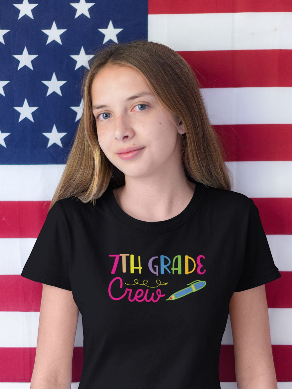 Sea Dragon Dreams black cotton Seventh Grade Crew t-shirt worn by a girl in front of an American flag background