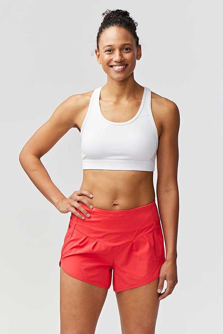Sea Dragon Dreams Sheva women's high rise running shorts in bright coral with a pleated design and flat waistband.