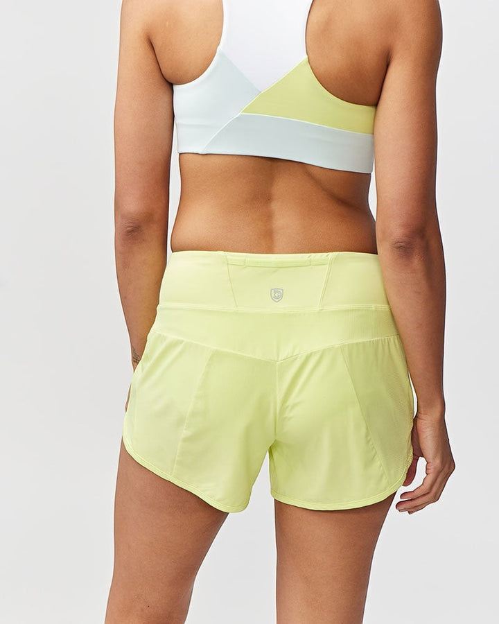 Sea Dragon Dreams Sheva high rise running shorts in pale yellow with a flat knit waistband and back zip pocket