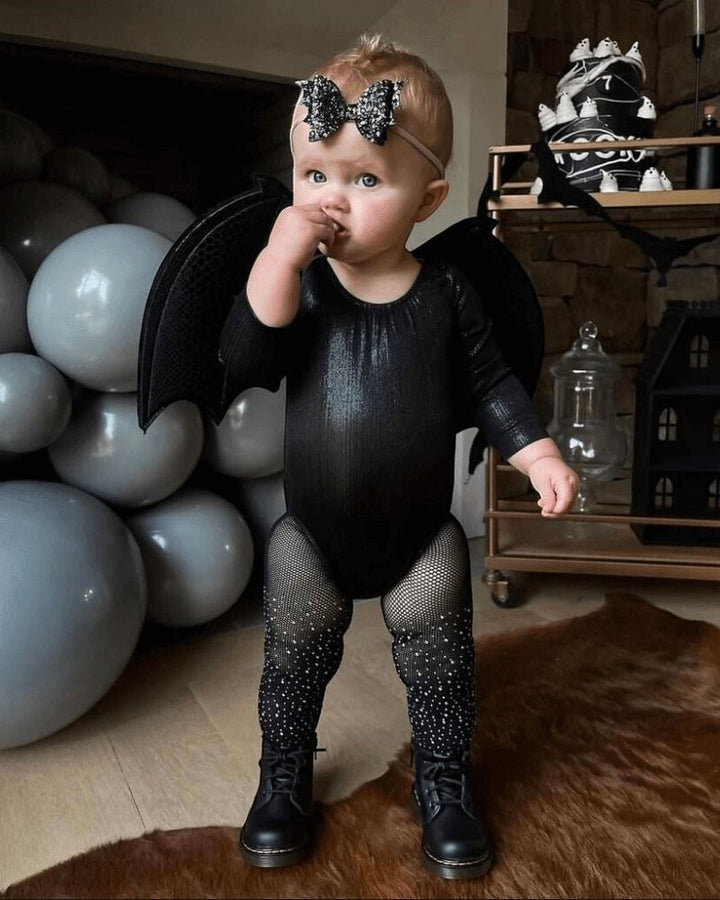 Sea Dragon Dreams girls' shimmering black long sleeve leotard worn as a bat costume with wings and fishnet tights