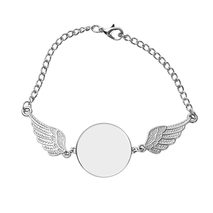Sea Dragon Dreams silver memorial bracelet featuring a circular photo charm flanked by delicate angel wings