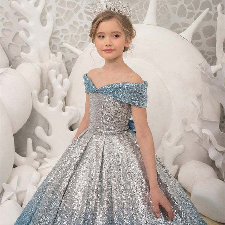 Sea Dragon Dreams girl wearing a sparkling silver and blue sequin princess dress with an off-shoulder neckline