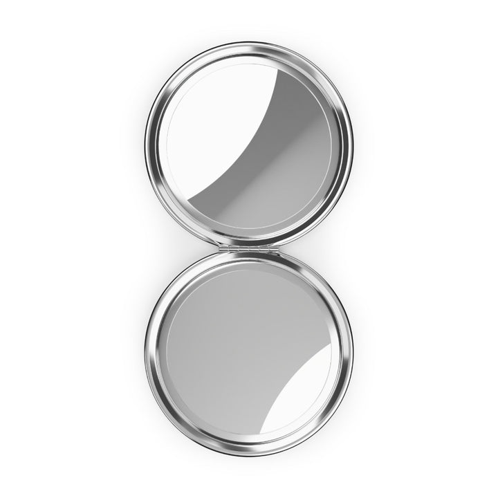 Sea Dragon Dreams round silver metal compact travel mirror with dual interior glass mirrors open on a white background