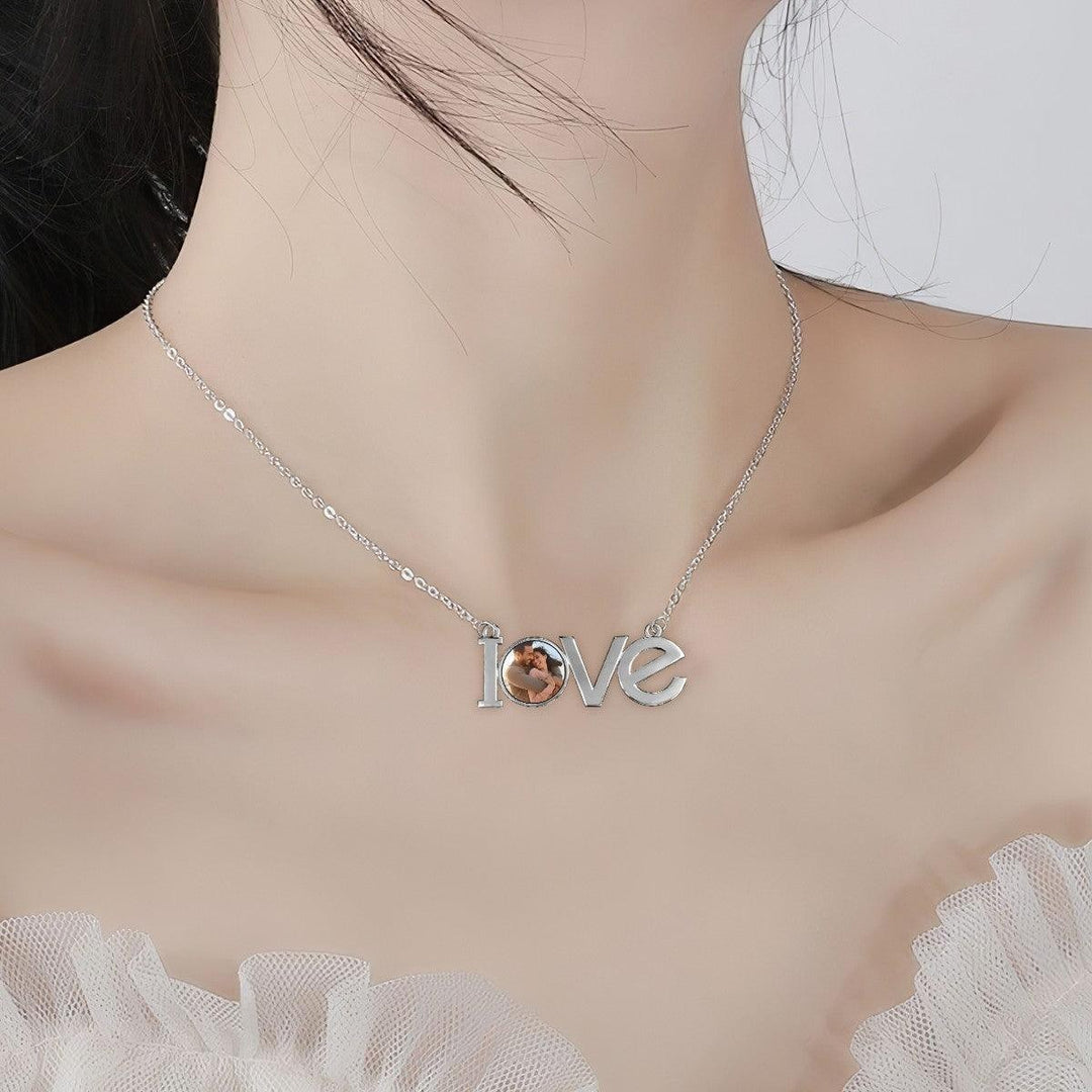 Sea Dragon Dreams silver-tone LOVE pendant necklace featuring a personalized circular photo charm worn on a model.